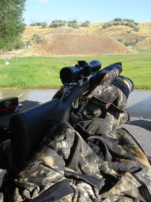 Browning X-Bolt on shooting bags and bench at the shooting range